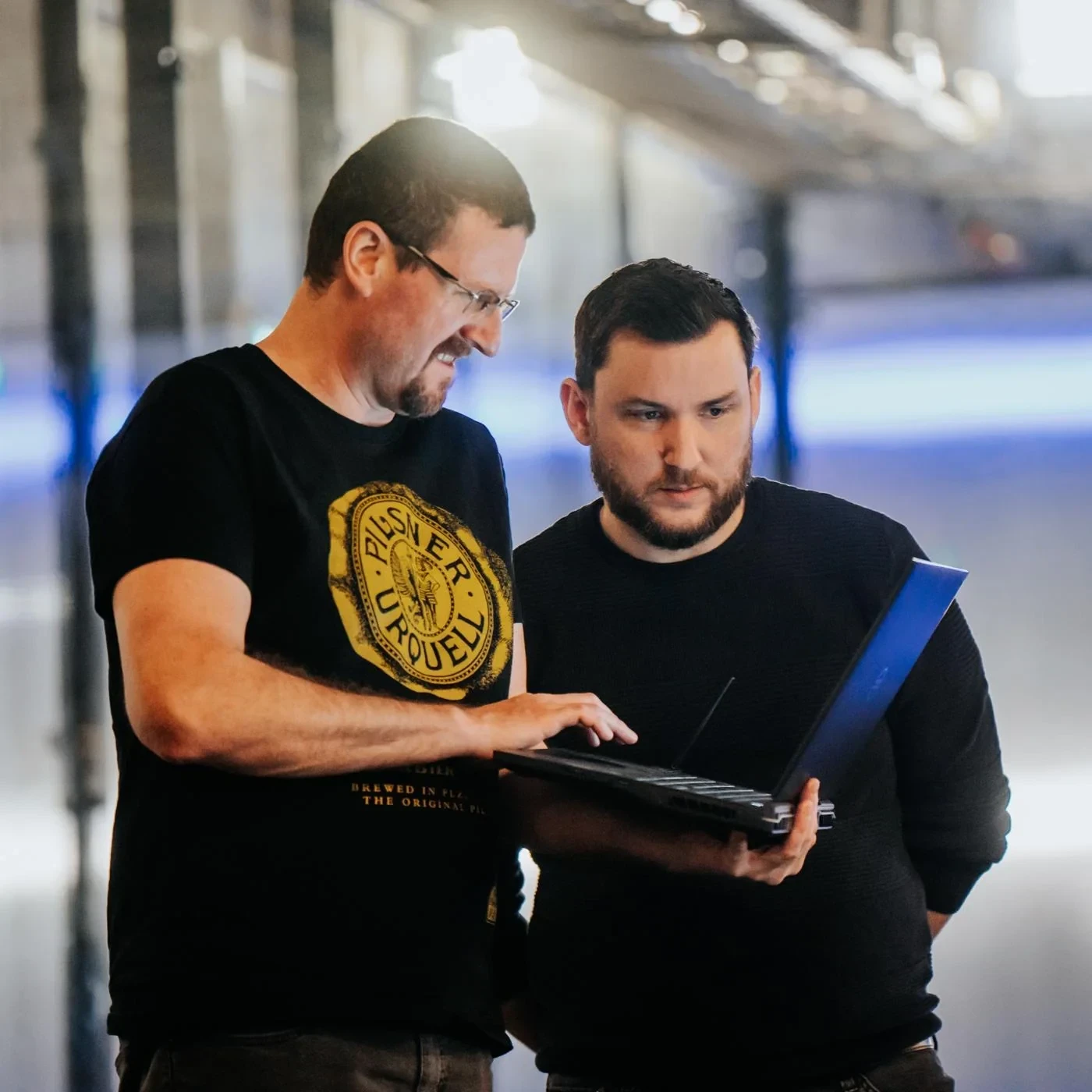 Sean Diehl and a colleague looking at a laptop together